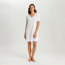 Load image into Gallery viewer, Embrace modern comfort with Hanro Cotton Silk Short-Sleeved Nightdress. This piece features a soft, mercerised cotton interlock construction, enhanced by subtle silk details. The short sleeves and ideal length of 90cm makes it perfect for a stylish and comfortable night's rest or relaxed lounging.
