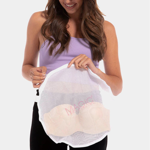 A Woman holding the Laundry bag, with a bra in it.