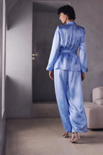 Load image into Gallery viewer, The Bea pyjamas embody a bold and contemporary elegance. Made of 100% heavy-weight silk, it plays on the contrasts between structure and fluidity, for a silhouette that is both assertive and comfortable.

The pants, flexible and fluid, have subtle pleating to create a beautiful volume with lightness. The elasticated waist at the back, guaranteeing a perfect fit.

The tailored jacket, draws a clean line thanks to its thin collar and integrated shoulder pads. Its wide belt emphasises the waist and structures 
