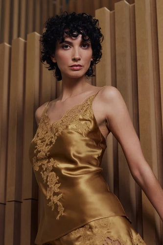 Caramel gold colour set.
This Marjolaine camisole and French knicker set is generously embellished with appliqué Calais lace. Camisole has spaghetti adjustable straps and the appliqué lace forms a sumptuous detail on the front, continuing down the front of the garment. The French Knickers have a sumptuous detail of appliqué lace on both hips. Its tone-on-tone Calais lace makes it a piece rich in luxurious details, while maintaining an airy yet comfy cut.