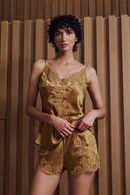 Load image into Gallery viewer, Caramel gold colour set.
This Marjolaine camisole and French knicker set is generously embellished with appliqué Calais lace. Camisole has spaghetti adjustable straps and the appliqué lace forms a sumptuous detail on the front, continuing down the front of the garment. The French Knickers have a sumptuous detail of appliqué lace on both hips. Its tone-on-tone Calais lace makes it a piece rich in luxurious details, while maintaining an airy yet comfy cut.
