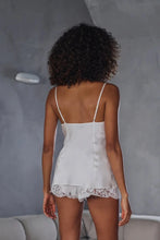 Load image into Gallery viewer, Ivory set.
This Marjolaine camisole and French knicker set is generously embellished with appliqué Calais lace. Camisole has spaghetti adjustable straps and the appliqué lace forms a sumptuous detail on the front, continuing down the front of the garment. The French Knickers have a sumptuous detail of appliqué lace on both hips. Its tone-on-tone Calais lace makes it a piece rich in luxurious details, while maintaining an airy yet comfy cut.
