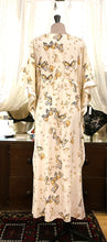 Load image into Gallery viewer, A beautiful, loose fitting pure silk Kaftan. The satin finish of the silk is on the inside, giving a sensuous sensation against the skin. The outside has a stunning butterfly print on a butter cream silk ground. There is a drawstring detail under the bust to allow for an individual fit. This is a striking garment. It is perfect for home, or as outerwear, beach or cruise wear.  One Size. Fabric: Printed Pure Silk  Made in France.
