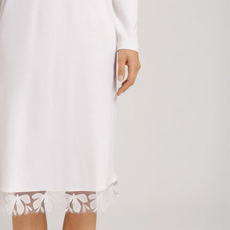 A close up of the hem of the Off White nightdress. Highlighting the beautiful embroidered lace trim.