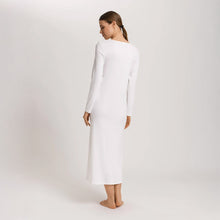 Load image into Gallery viewer, Image of the back of a woman wearing an Off White long sleeve full length nightdress. The garment has a lovely feminine flow to it and a slit on the side to allow for comfortable movement.
