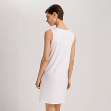 Load image into Gallery viewer, Image of the back of a woman wearing an Off White sleeveless short (knee length) nightdress. The garment has a lovely feminine flow to it.
