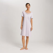 Load image into Gallery viewer, A woman wearing a Pink Lavender short (knee length) nightdress and short sleeves with a lace trim on the neckline. The garment has a lovely feminine flow to it.
