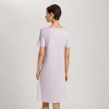 Load image into Gallery viewer, Image of the back of a woman wearing a Pink Lavender short (knee length) nightdress and short sleeves. The garment has a lovely feminine flow to it.
