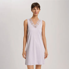 Load image into Gallery viewer, A woman wearing a Pink Lavender sleeveless short (knee length) nightdress. The deep V-neck is adorned with a wide embroidered lace trim on tulle. The garment has a lovely feminine flow to it.
