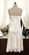 Load image into Gallery viewer, Butter/Ivory. Made in Italy, this is a beautiful long pure silk satin night/slip. There is stunning deep appliqué lace at the bust and hem. There are French seams throughout for softness. The fine spaghetti straps are adjustable for the perfect fit. This nightslip is cut on the bias and panelled giving lovely flare and movement. Perfect for bed or daywear. May be worn as underwear, nightwear or outerwear.   Composition: 100% Silk Satin Italian Lace 100% polyamide Machine washable Length 82cm from nape.
