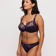 Load image into Gallery viewer, Woman wearing a dark purple lace bra and panties set on a white background
