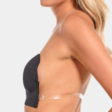 Load image into Gallery viewer, Person wearing a black strapless bra with a cleat plastic back strap on a light gray background.
