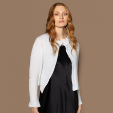 Load image into Gallery viewer, Woman wearing a Vinage Ivory cashmere bed jacket over a white shirt against a brown background
