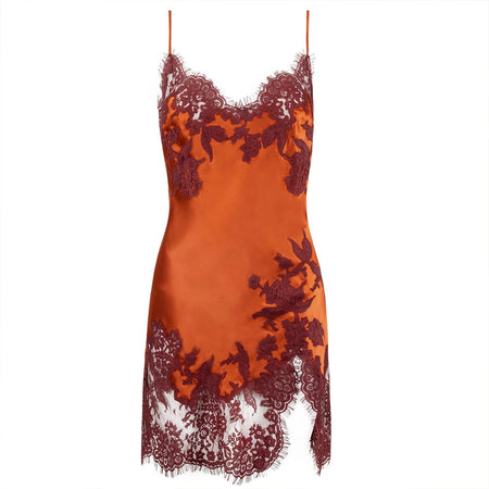 A deep orange satin slip dress with dark red floral lace appliques and matching lace trim along the neckline, straps, and hem, shown against a plain white background.
