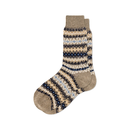 A pair of knit cashmere socks with a Fair Isle pattern in beige, navy blue, and light blue, shown against a plain white background.