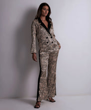 Load image into Gallery viewer, Aubade pure silk classic &#39;men&#39;s style&#39; pyjama but with extra flair. Made from 100% pure heavy weight silk. The double-breasted jacket has a revere collar in black, contracting beautifully with the stylish Feline print.  The trousers have a wide waistband which is mirrored in a side stripe down the flared trouser leg. The side slit at the ankle completes these gorgeous set. Perfect for sleep, leisure or outerwear.
