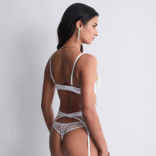 Load image into Gallery viewer, Giving the chest a very sexy natural curve, the Aubade&nbsp;Satin Memories underwire balconnette bra deploys a graphic French embroidery inspired by the waves, accentuated at the centre and on the straps by very elegant golden touches. On the back, it is adorned with a luminous and light Italian satin for optimal comfort.
Image of the back
