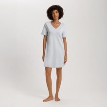 Load image into Gallery viewer, A woman wearing a Powder Blue short sleeve cotton silk above knee length 90 cm long nightdress. It has a silk trim on the V-neck as well as on the sleeves and the hem. 
