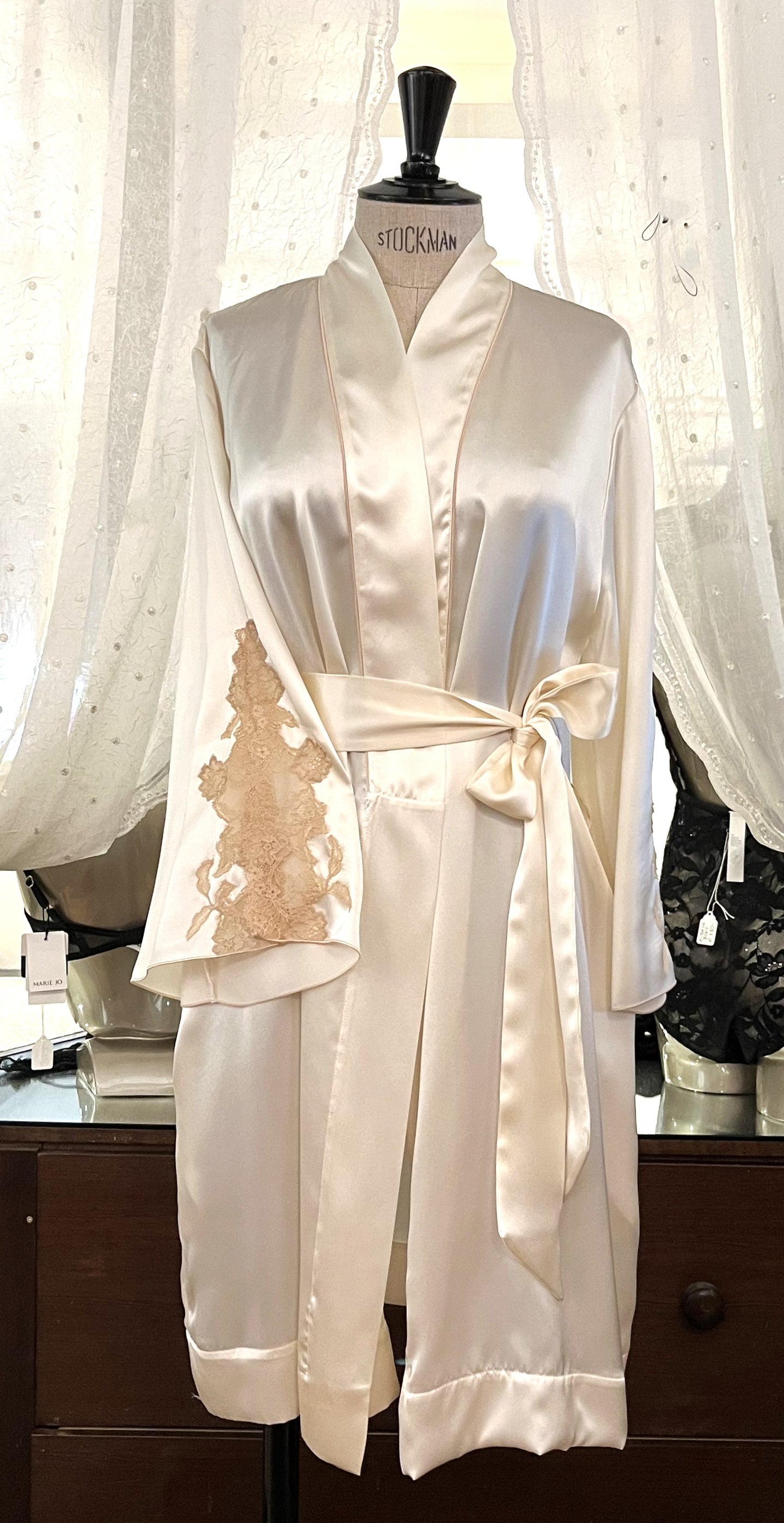 Ivory/Ecru. Beautiful Pure Silk Robe.  Generous Belted at the waist contrasting lace on the sleeve and matching black piping on the Kimono style collar. Two concealed side pockets. Wonderful to wear over any item or nightwear, or to match with our Verdiani Night/Slips.  100% Silk Satin. Lace: 78% Nylon, 16% Elastane, 6% Polyester. Made in Italy. Machine washable. Loose fitting for comfort and movement. 