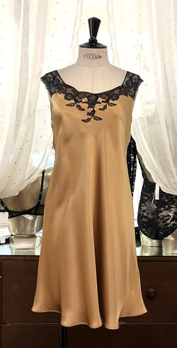 Camel/Black. Classic, short night/slip. Made from 100% silk satin. The wide lace straps have a gentle elasticity for fit and comfort.  Appliqué lace detail continues to the round neck. Cut on the bias for movement and swing. This garment is perfect for sleepwear or loungewear. Generous sizing, if in doubt select the smaller size.   100% Silk Satin. Lace: 78% Nylon, 16% Elastane, 6% Polyester. Made in Italy. Machine washable.
