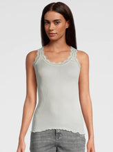 Load image into Gallery viewer, Ivory. Singlet style delicate fine ribbed knit fabric in pure silk organza with the most elegant and feminine French leavers lace and the neckline and shoulder. The lace is certified and numbered as true “Dentelle de Calais®”. Super-soft touch with no side seams, the construction is for the ultimate in comfort. Featuring a gently scooped neckline this singlet allows for a multiple of uses, as underwear or outerwear.  100% Silk All Oscalito Sik is certified GOTs. Machine washable
