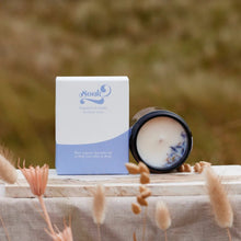 Load image into Gallery viewer, Candle and packaging with &#39;Soak&#39; branding on a wooden surface with dried plants.
