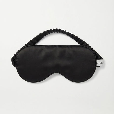 A black pure silk satin sleep mask with an elasticized strap, displayed flat against a clean white background.