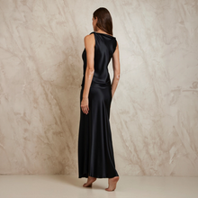 Load image into Gallery viewer, Woman wearing a black sleeveless Top and Slip Skirt against a beige marble background
