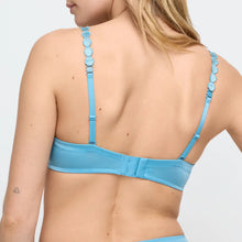Load image into Gallery viewer, Blue bikini top worn by a person on a white background
