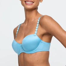 Load image into Gallery viewer, Light blue bikini top worn by a model on a plain background
