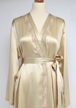 Load image into Gallery viewer, Beautiful full length dressing gown in pure silk satin in a collarless kimono style. It has 2 side pockets and belted at the waist. The appliqué lace runs the entire length of the wrapover section of the robe. This is a classic style, with clean simple lines but with an added touch of luxury with its lace detailing.  Fabric Content: 100% Pure Silk Made in Italy Machine washable.
