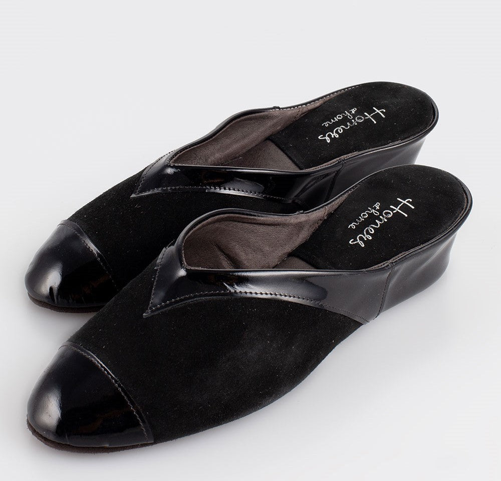 Very graceful suede and patent leather slippers. The vamp is a combination of suede and leather. The insole is padded for extra comfort. Stylish patent leather on the toe continues as a detail on the top of the vamp and around to the gentle heel. The low heel is elegant and gives a little height if required. Perfect for home or outerwear.