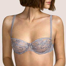Load image into Gallery viewer, This is a perfect balconnet bra. The horizontal seam blends attractively with the embroidery, forming a beautifully shaped cup. The double satin spaghetti straps create delicacy with strength. Andres Sarda is famous for its innovation in its use of fabrics. Tina in Metallic Silver is a perfect example.  Fabric Content: Polyester: 50%, Polyamide: 44%, Elastane: 6%
