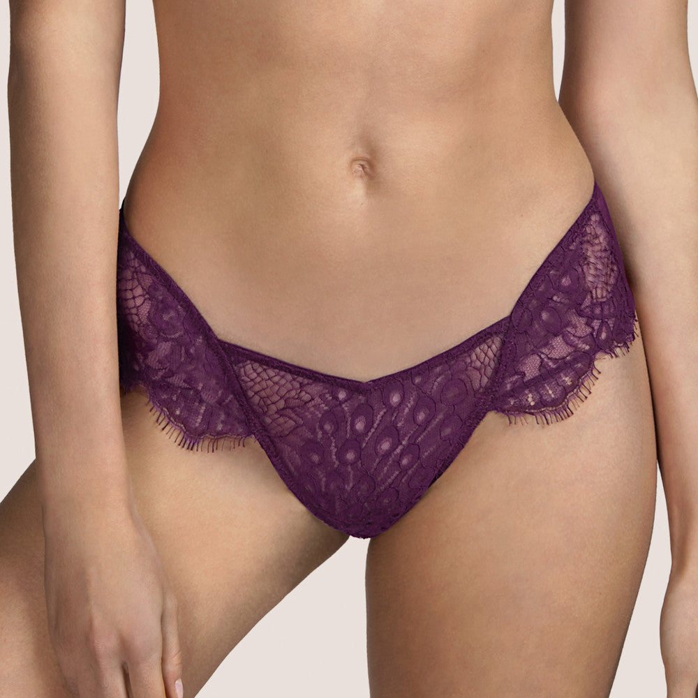 Beautiful low-cut Tanga style G/String. The front made entirely of Leavers lace. The back is a classic style sheer tulle G/String, perfect for smoothness under clothing. The colour Tourmaline is an Aubergine shade, perfect for all skin tones.    Fabric Content: Polyamide: 42%, Polyester: 28%, Cotton: 26%, Elastane: 4%