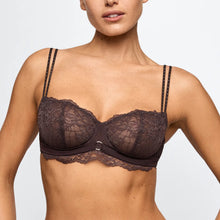 Load image into Gallery viewer, Black lace bra worn by a model on a plain background
