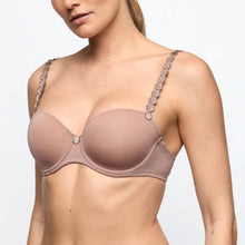 Load image into Gallery viewer, Woman wearing a beige bra with decorative straps on a light gray background
