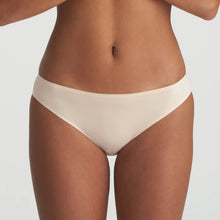 Load image into Gallery viewer, Beige bikini bottom worn by a person on a light gray background
