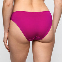 Load image into Gallery viewer, Person wearing bright pink underwear on a plain background

