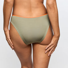 Load image into Gallery viewer, Person wearing olive green bikini bottoms with orange waistband on a light gray background
