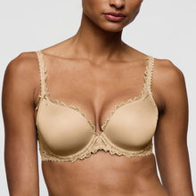 Load image into Gallery viewer, Beige bra with lace details worn by a model on a plain background
