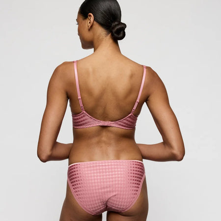 Person wearing a pink bikini set on a white background