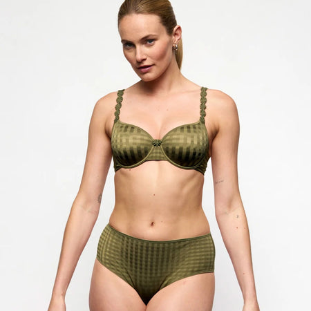 Woman wearing a green lingerie set on a white background
