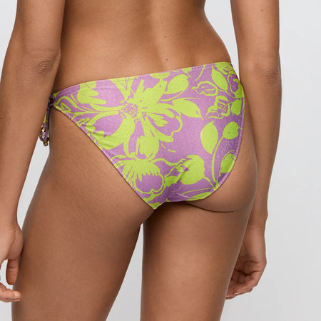 Purple and green floral bikini bottom on a plain background