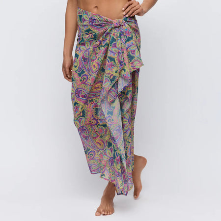 Colorful paisley patterned sarong on a plain background