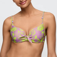Woman wearing a purple and green floral bikini top on a white background