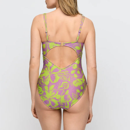 Purple and green floral swimsuit on a plain background