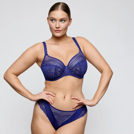 Woman wearing a blue lingerie set on a white background
