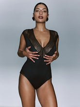 Load image into Gallery viewer, Model wearing a black swimsuit with mesh details against a gray background
