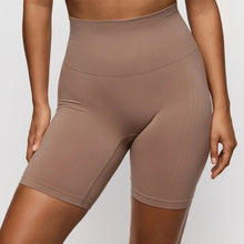 Load image into Gallery viewer, Brown high-waisted shorts worn by a person on a plain background
