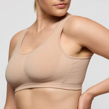 Load image into Gallery viewer, Beige bra worn by a person on a light gray background
